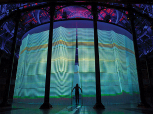 A visitor walks through the silicone threads of 'Curtain Call' at the Roundhouse theater in London. All images courtesy of Ron Arad. 