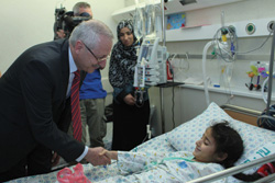 Dr. Hani Abdeen (left) meets with a young patient at Hadassah Hospital. 