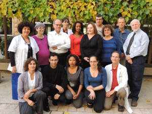 Michele Bashan-Haouzi (far left), Dr. Shlomo Maayan (third from left), Estelle Rubinstein  (third from right) with AIDS center staff.