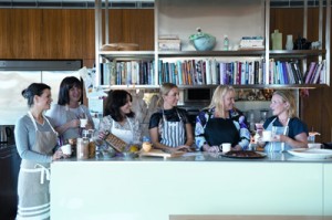 Club members drinking tea, and dishing on food.