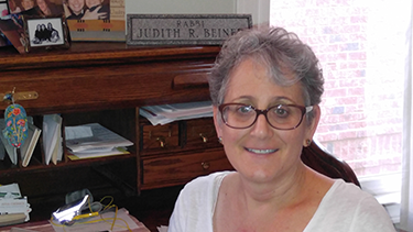 The gifted stone "tombstone" holds pride of place on Rabbi Beiner's desk.