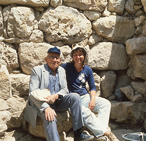 A young Eilat Mazar sitting with her grandfather, Benjamin Mazar. Courtesy of Eilat Mazar.