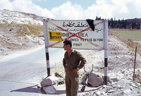 A guard stands at the newly opened road up to Mount Scopus.